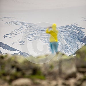 Young woman admiring the natural beauty of a glacier