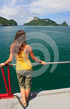 Young woman admiring scene from a boat, Ang Thong National Marin
