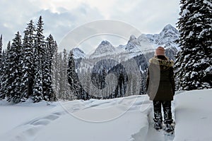 A young woman admiring the snowy views of Island Lake in Fernie, British Columbia, Canada.