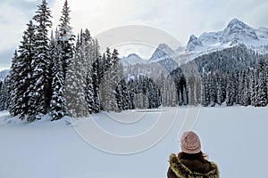 A young woman admiring the snowy views of Island Lake in Fernie, British Columbia, Canada. photo