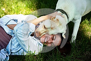 Young woman adopt young dog Labrador Retriever from animal rescue center and gave him love and friendship. Female animal lover