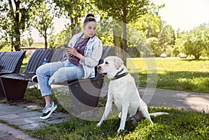 Young woman adopt young dog Labrador Retriever from animal rescue center and gave him love and friendship. Female animal lover spe