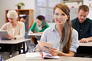 Young woman at adult education class looking to camera