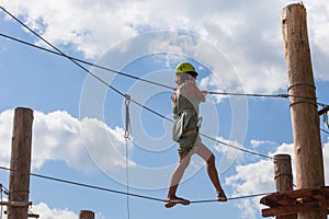Young woman in adventure park summer challenge