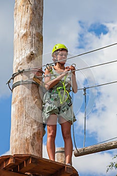 Young woman in adventure park summer challenge