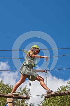 Young woman in adventure park summer challenge