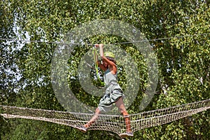 Young woman in adventure park summer challenge