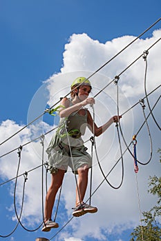 Young woman in adventure park summer challenge