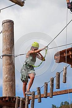Young woman in adventure park summer challenge
