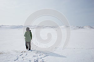 Young woman adventuring in a frozen lanscape photo