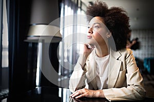 Young woman with afro hairstyle smiling in urban background