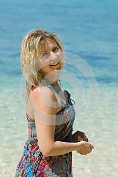 Young woman against the backdrop of the sea