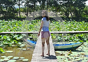 Young woman against Lotus lake in Vietnam