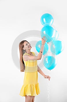 Young woman with air balloons