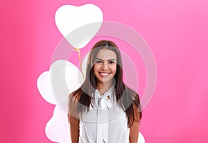 Young woman with air balloons on background. Celebration of Saint Valentine`s Day