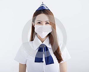 Young woman air hostess in uniform with white mask