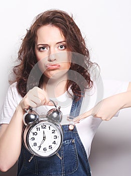 Young woman with alarmclock