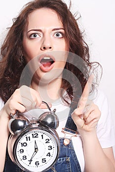 Young woman with alarmclock