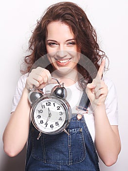 Young woman with alarmclock