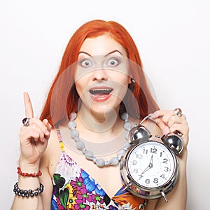 Young woman with alarmclock