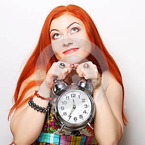 Young woman with alarmclock