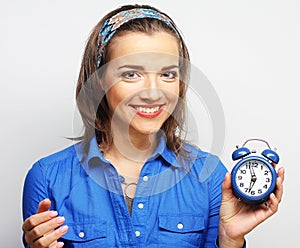 Young woman with alarmclock