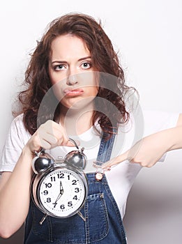 Young woman with alarmclock photo
