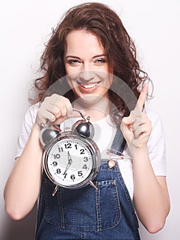 Young woman with alarmclock photo