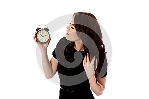 Young woman with alarmclock, isolated.