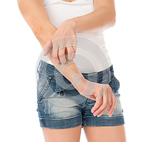 Young woman allery scratching her arm