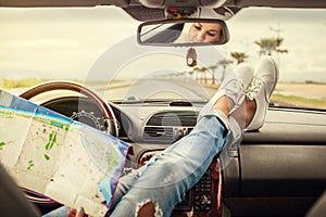 Young woman alone car traveler with map