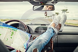 Young woman alone car traveler with map