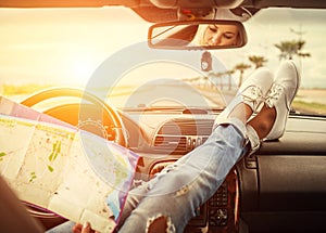 Young woman alone car traveler with map