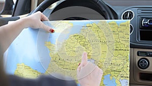Young woman alone car traveler with map