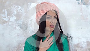 Young woman alone isolated on white wearing hat grimace disgusted