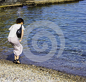 Young woman alone on a Mediterranean beach, France