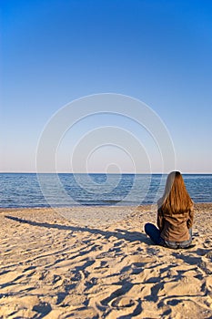 A young woman alone at the seaside