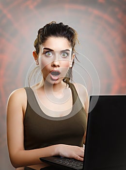 Young woman amazed and shocked by internet news