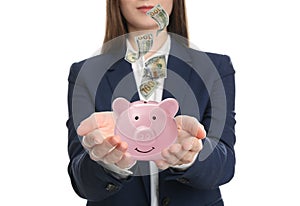 Young woman and American dollars falling into piggy bank on background, closeup