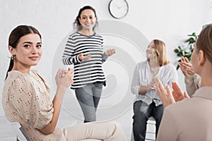 young woman applauding and looking at