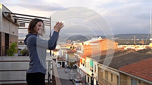 Young woman applauding to support workers during COVID