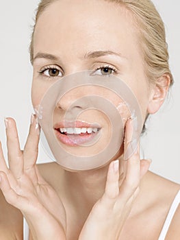 Young Woman Applying Facial Cream