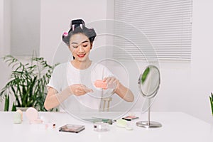 Young woman applying facial wipe on her face remover washing makeup, essence or lotion of skin care treatment