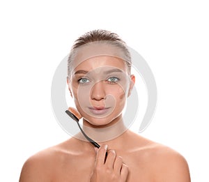 Young woman applying foundation on her face