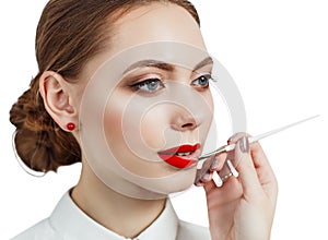 Young woman applying lipstick with an applicator