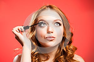 Young woman applying make up