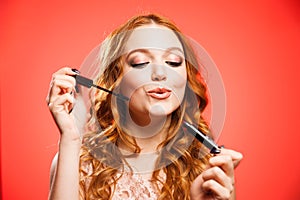 Young woman applying make up