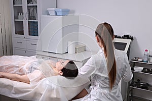 The young woman an appointment at the beautician in the beauty parlor. The concept of cosmetology, skin care, face and body