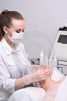 The young woman an appointment at the beautician in the beauty parlor. The concept of cosmetology, skin care, face and body