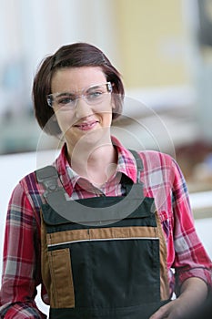 Young woman apprentice in carpentry school